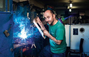 man welding at a manufacturing company
